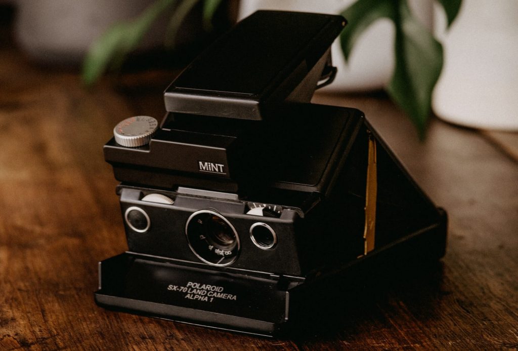 An image of an instant camera, a camera that produces instant prints.